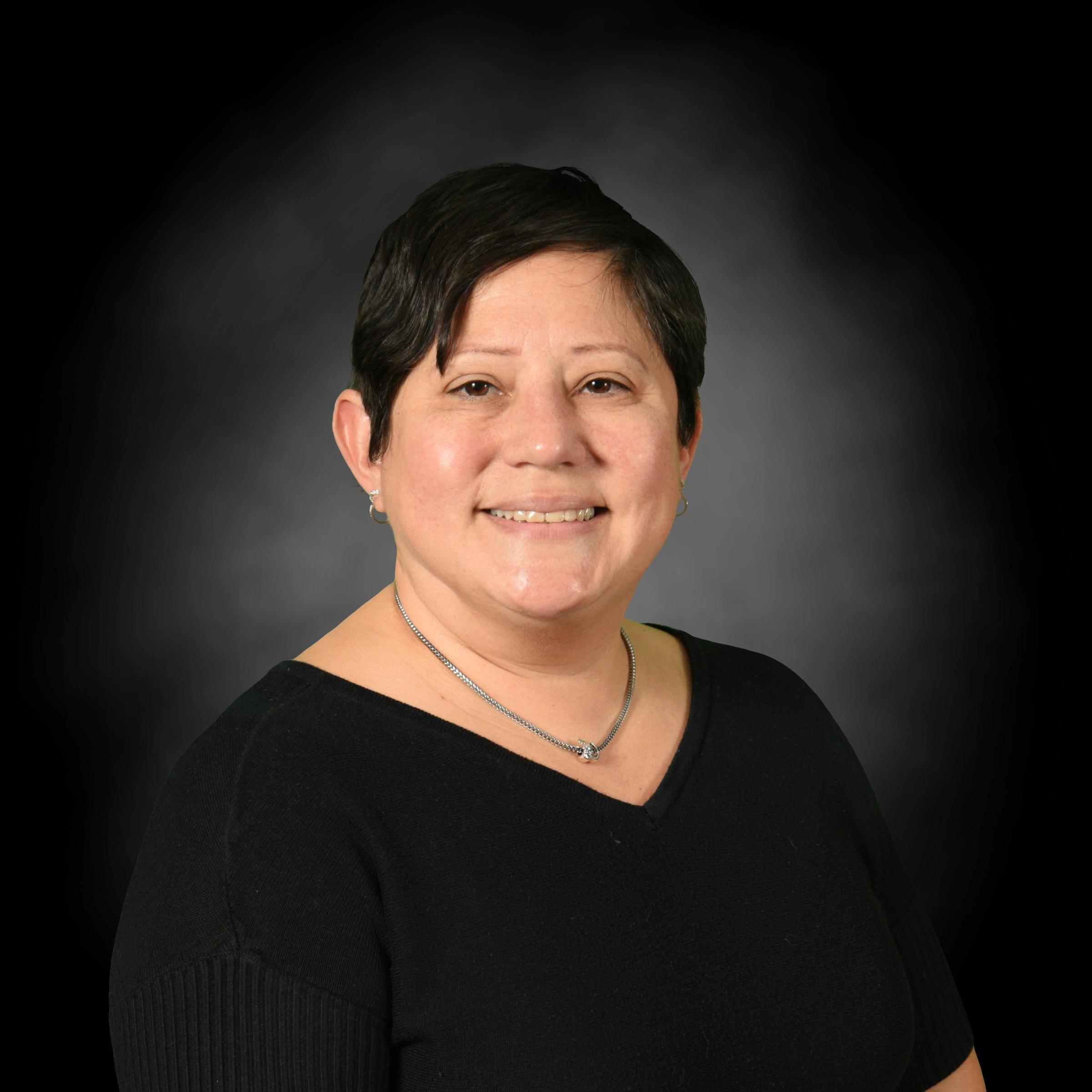 Barbara Algarin staff portrait photo smiling in black top