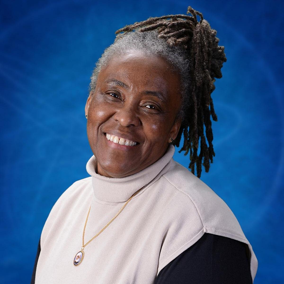 Delfina Domingos smiling in a professional staff portrait