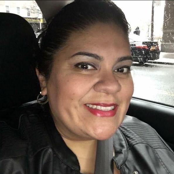 Cynthia Gallegos smiling in a vehicle wearing a black jacket
