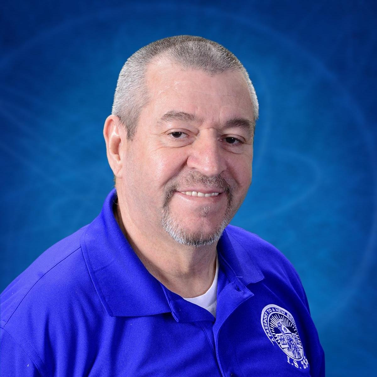 Ofairo Giraldo staff portrait in school polo shirt