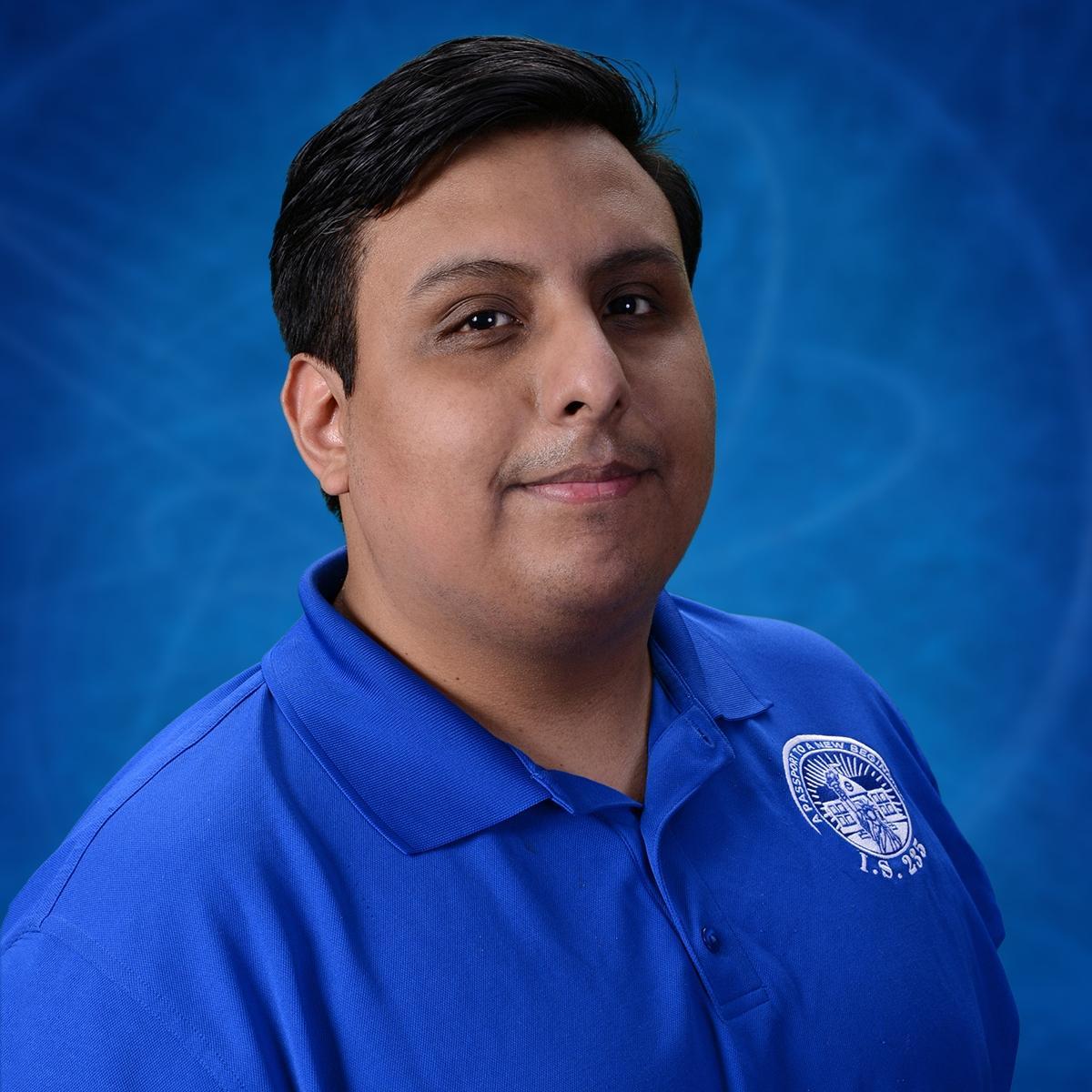 Sergio Valencia staff portrait wearing I.S. 235 polo shirt