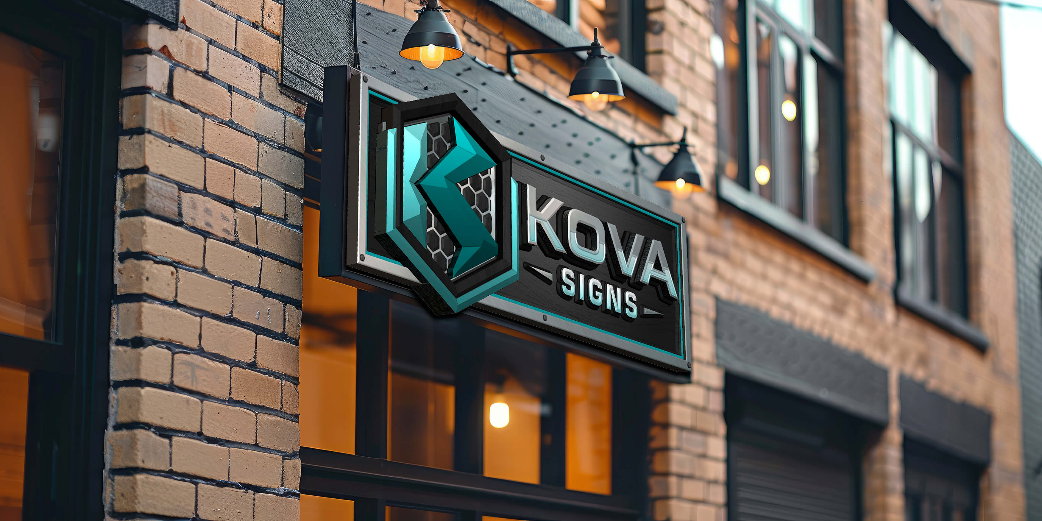 Exterior brick wall with a black and turquoise sign reading 'KOVA SIGNS' lit by three lamps.