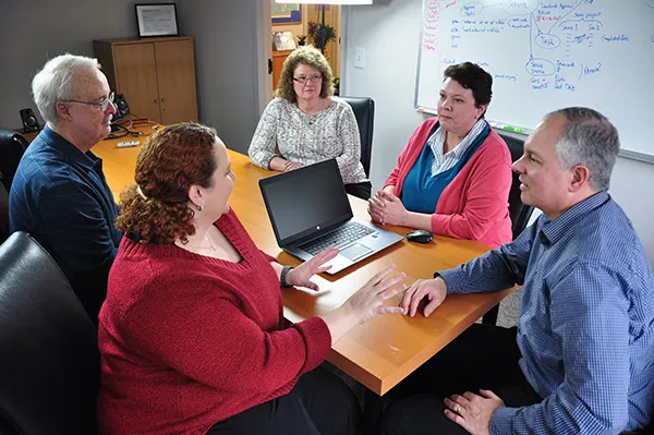 The J Street Technology team meeting around a conference table