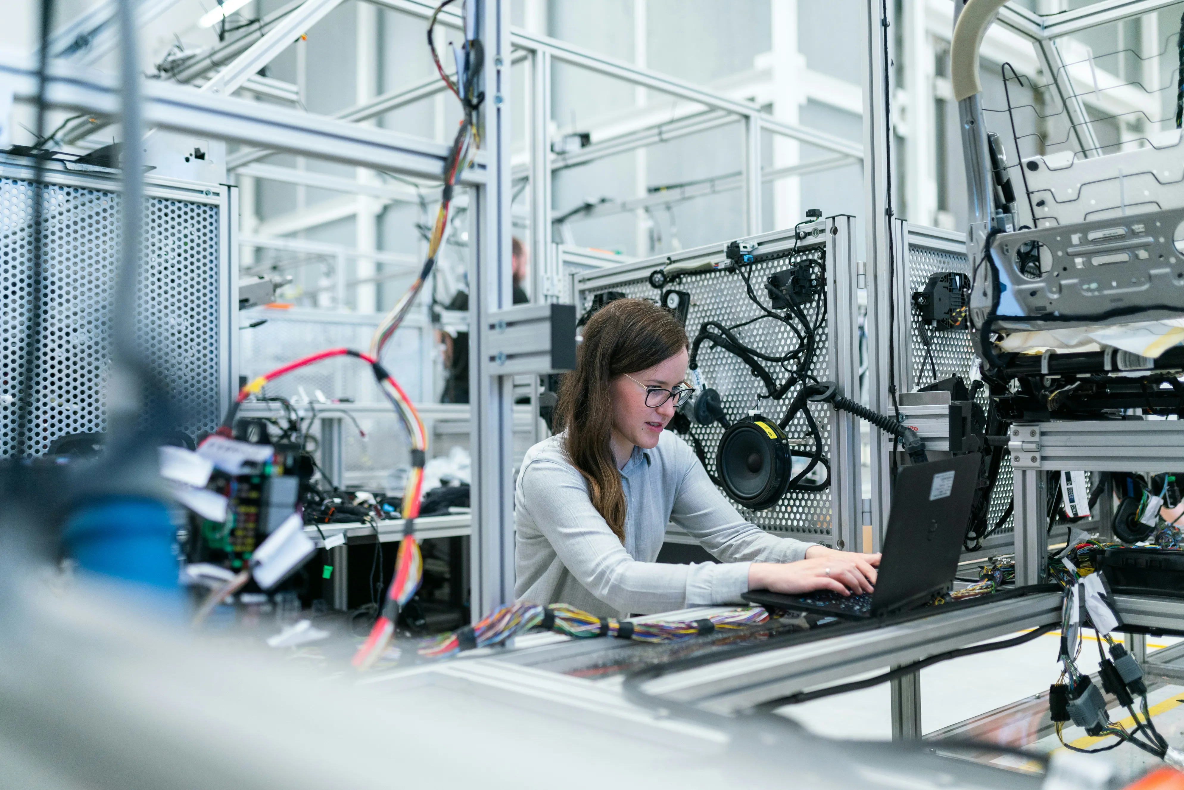 An engineer working at an electronics assembly workstation
