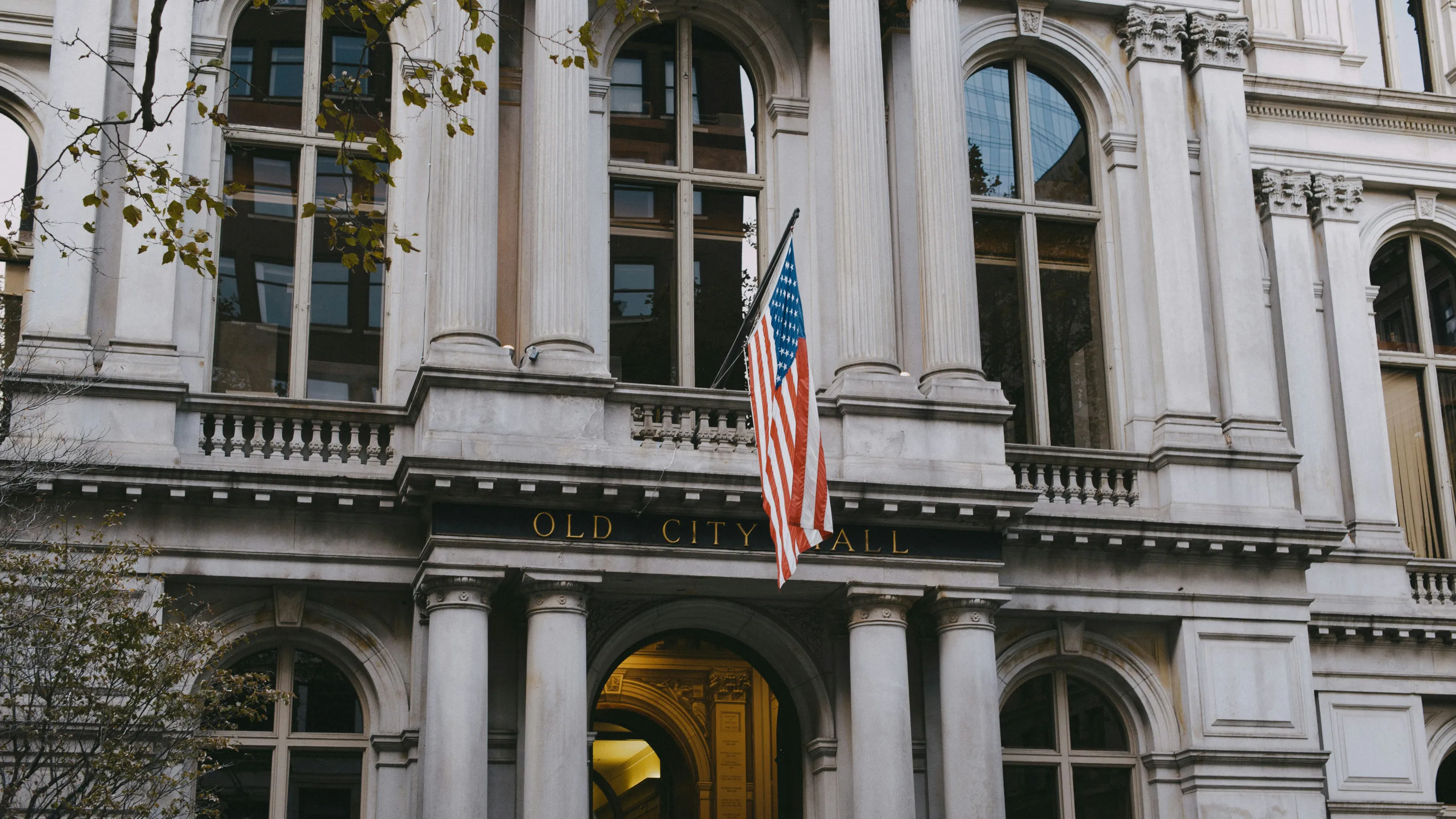 A historic government building with an American flag