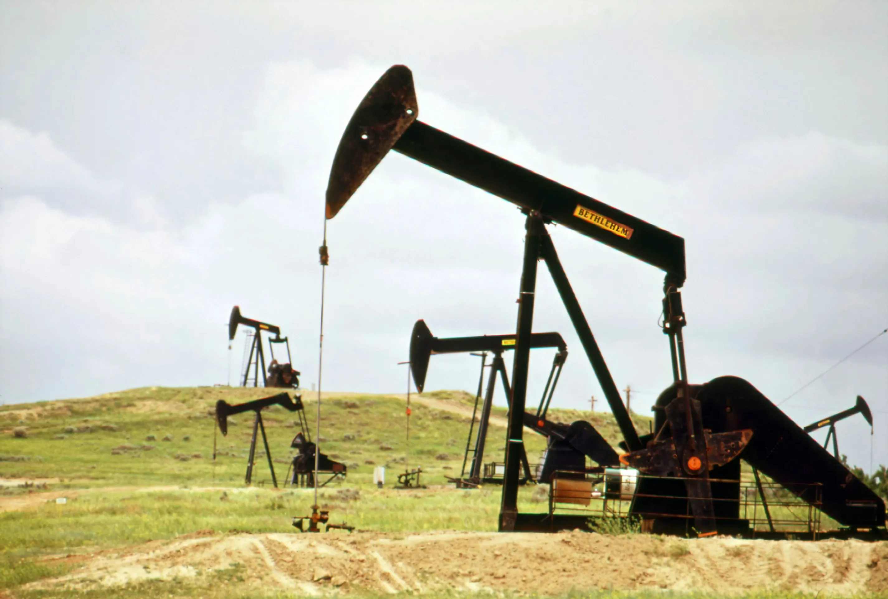 An oil pump jack in a grassy field