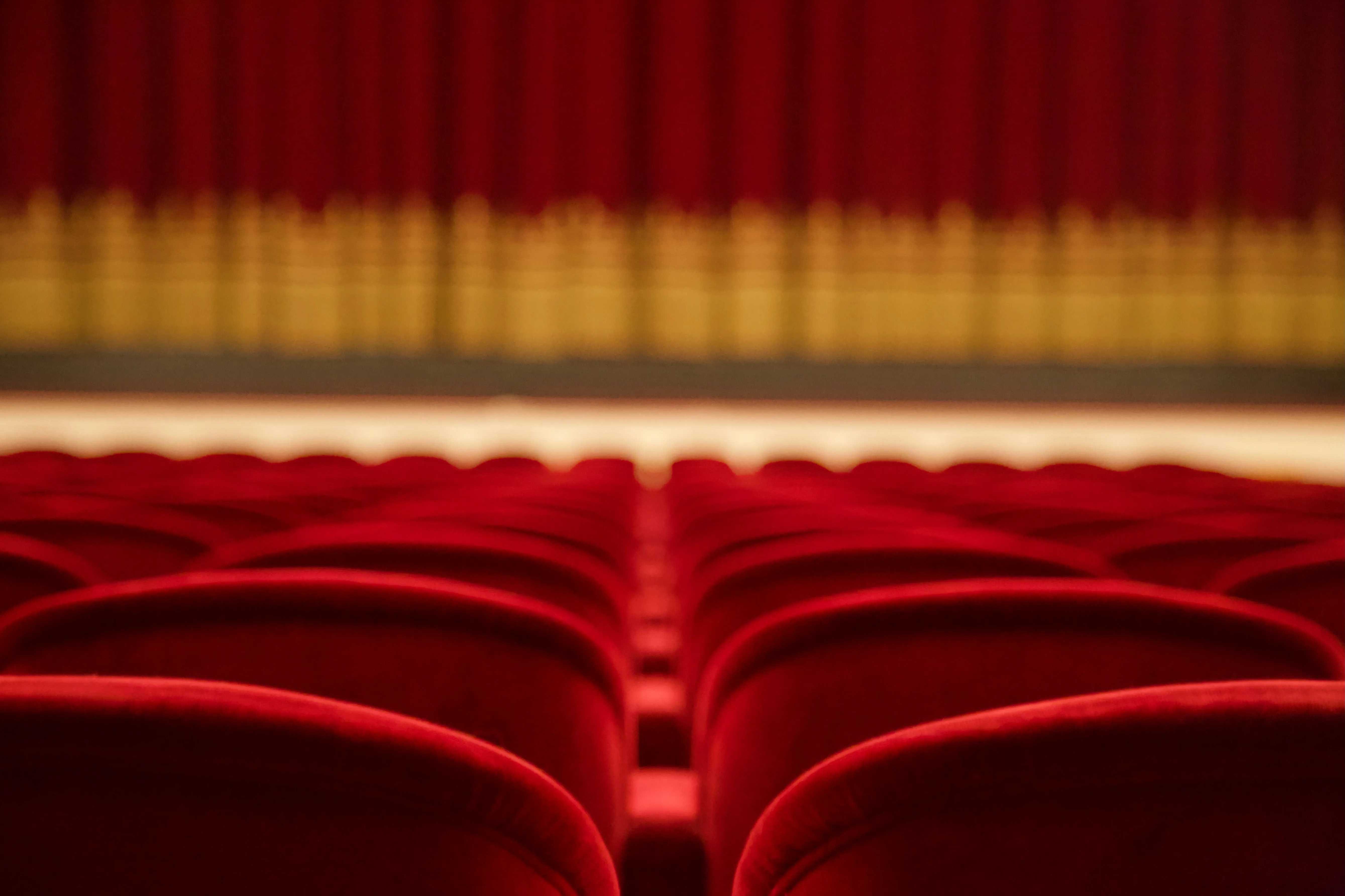 Rows of empty red theater seats