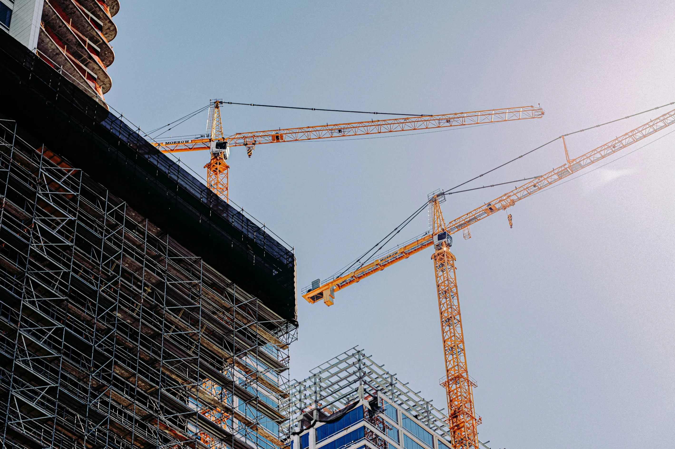 Construction cranes above a building under construction