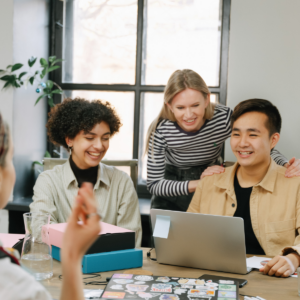Smiling team members sitting at desk