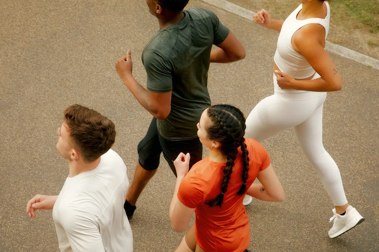 Group of friends running together outdoors