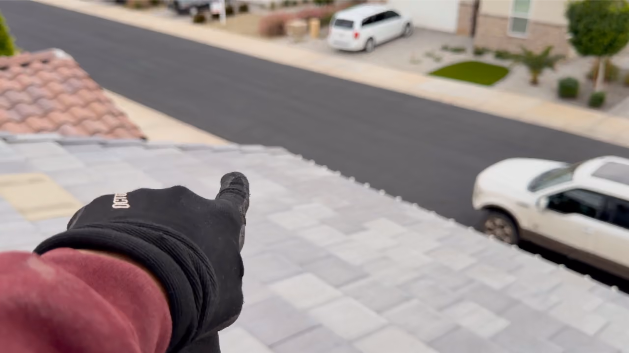 arthur from holiday lights university on a roof top pointing at professional grade C9 christmas bulbs installed on a home