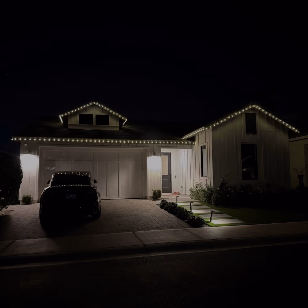 a completed professionally installed christmas light job that shows a home with white c9 christmas lights.