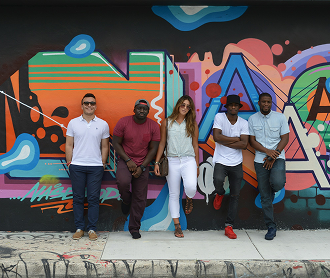 Five diverse people standing against a colorful graffiti wall with vibrant geometric shapes.
