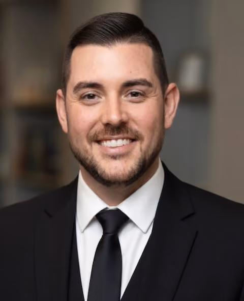 Headshot of Chad Reid, Chief Operating Officer at SummitView Holdings, wearing a black suit and tie.