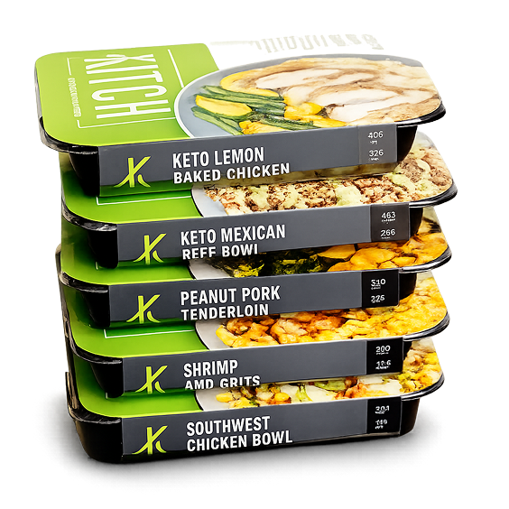 Stack of five packaged ready-to-eat meals with labels including Keto Lemon Baked Chicken and Southwest Chicken Bowl.