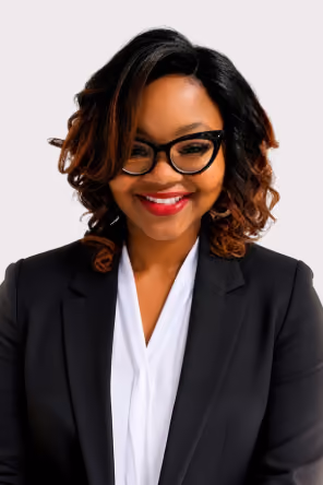 Woman with curly hair and glasses smiling wearing a light blue InMark Life Science shirt.