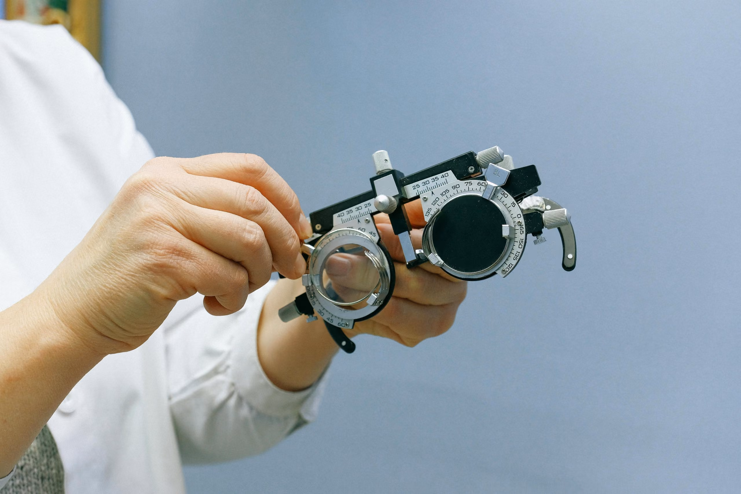 Person holding lens holder for glasses prescription verification