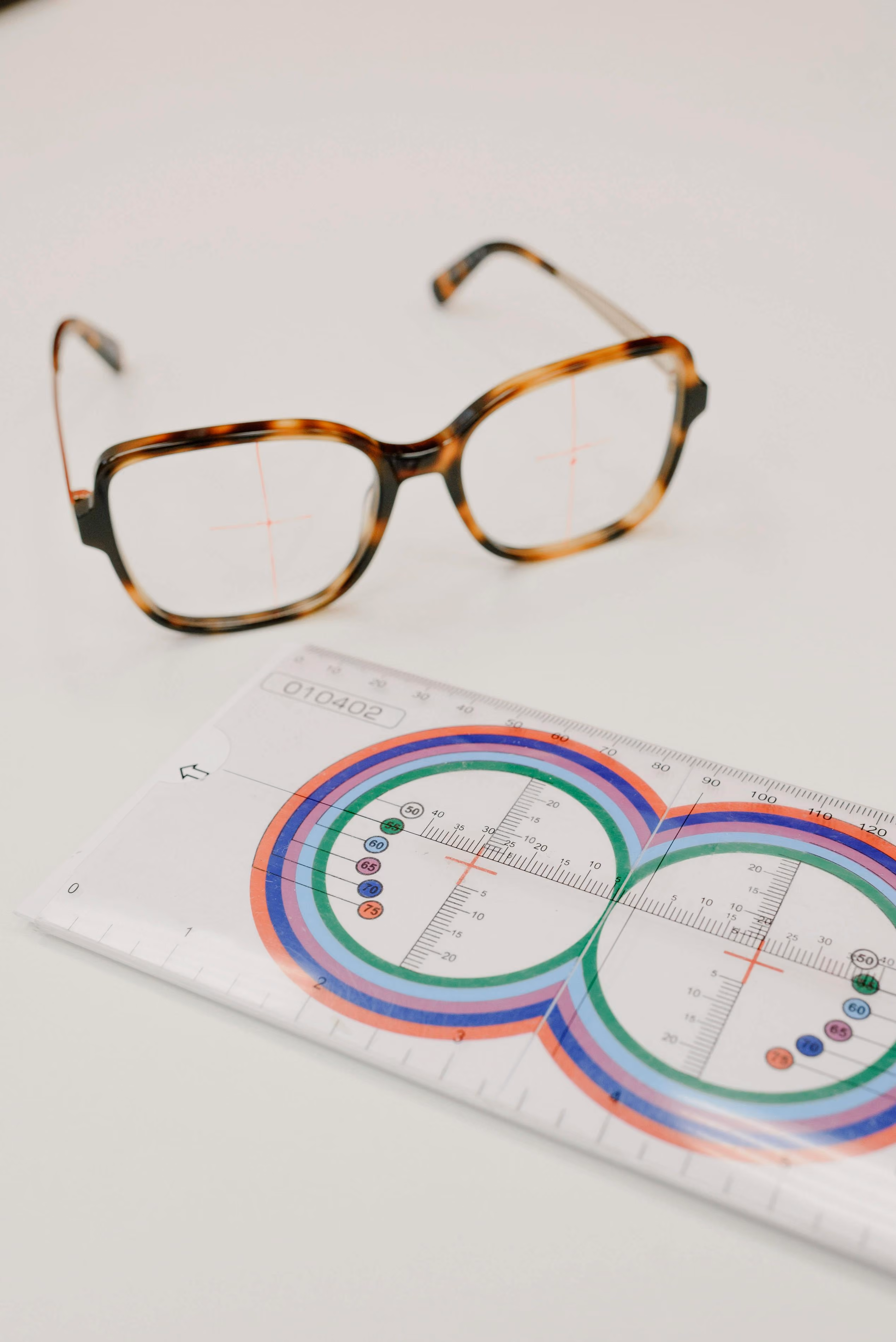 Glasses and a graph with colored dots are present.