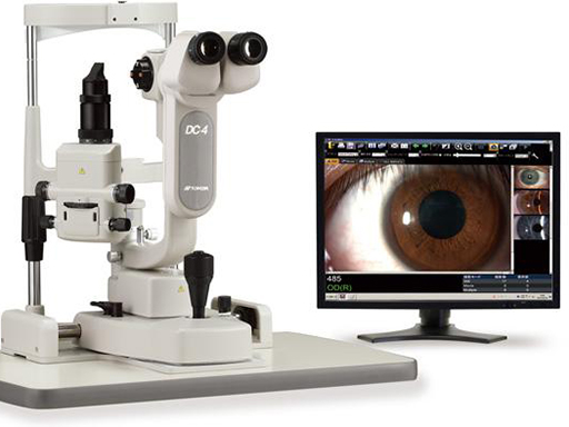 A microscope with a monitor showing an eye exam.