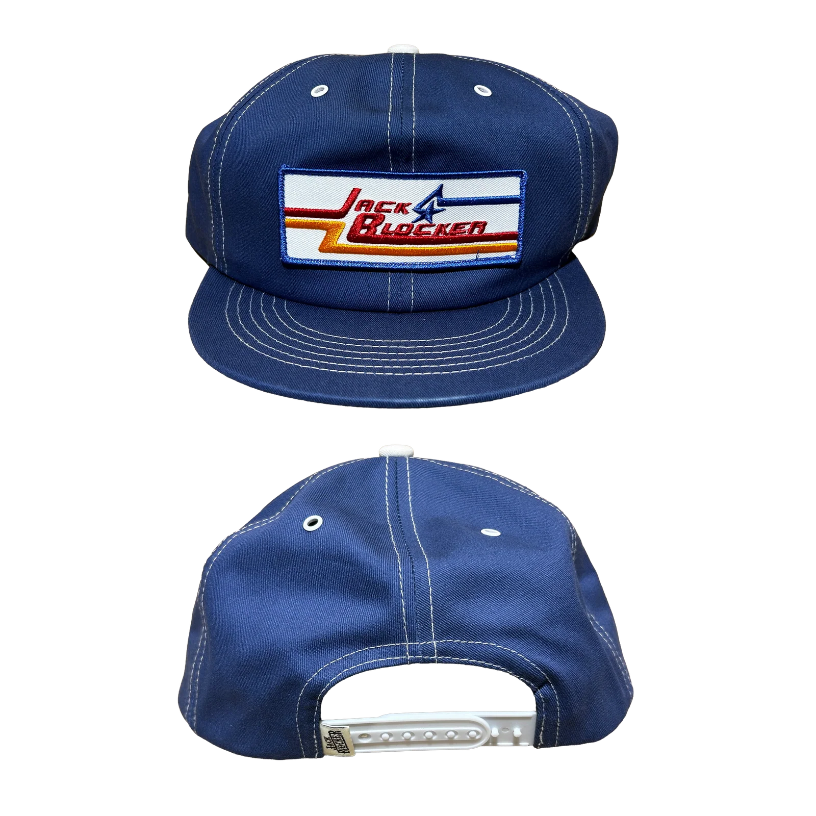 Navy blue snapback cap with white stitching and Jack Blocker logo patch on front panel.
