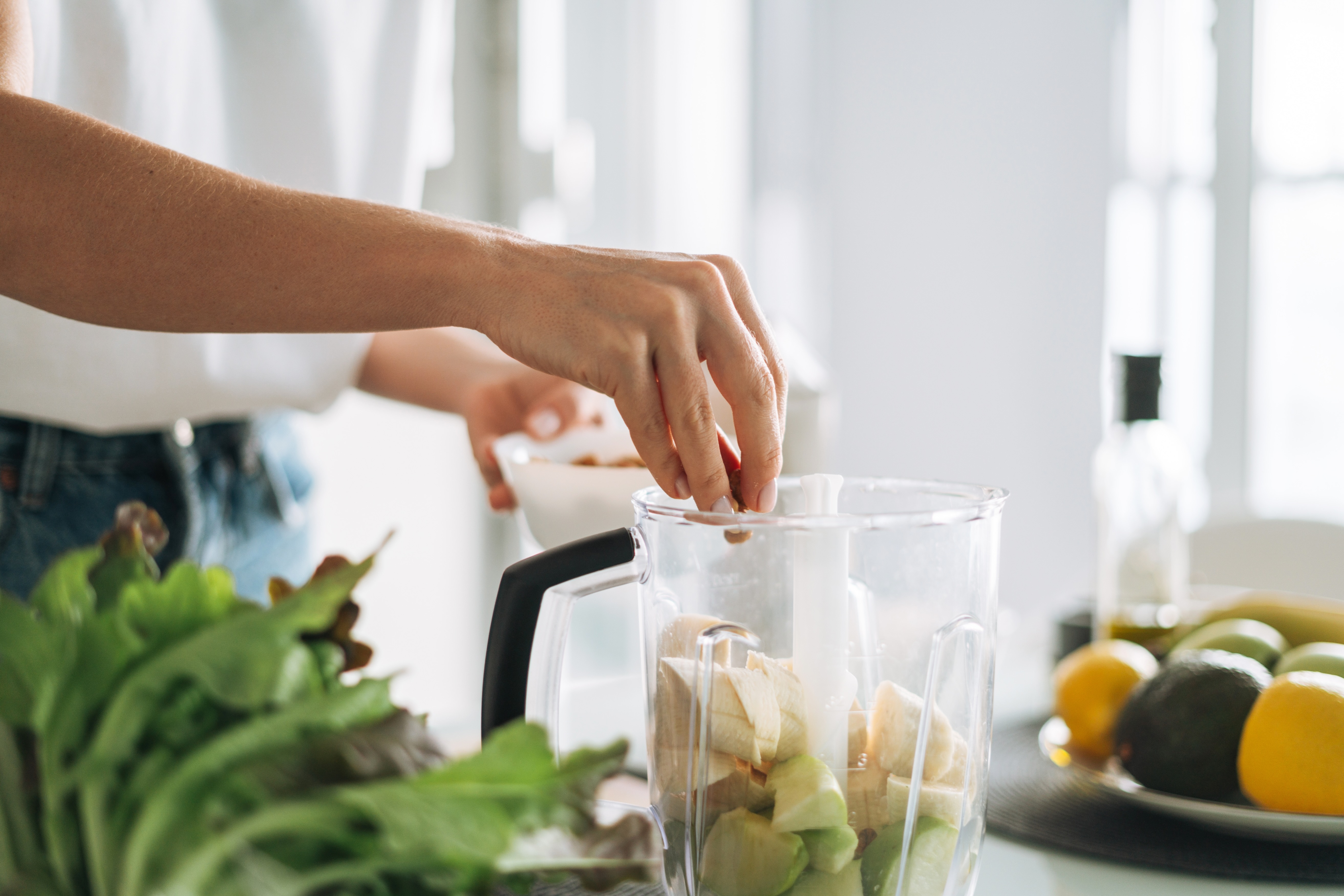 Person making smoothie in kitchen stock image