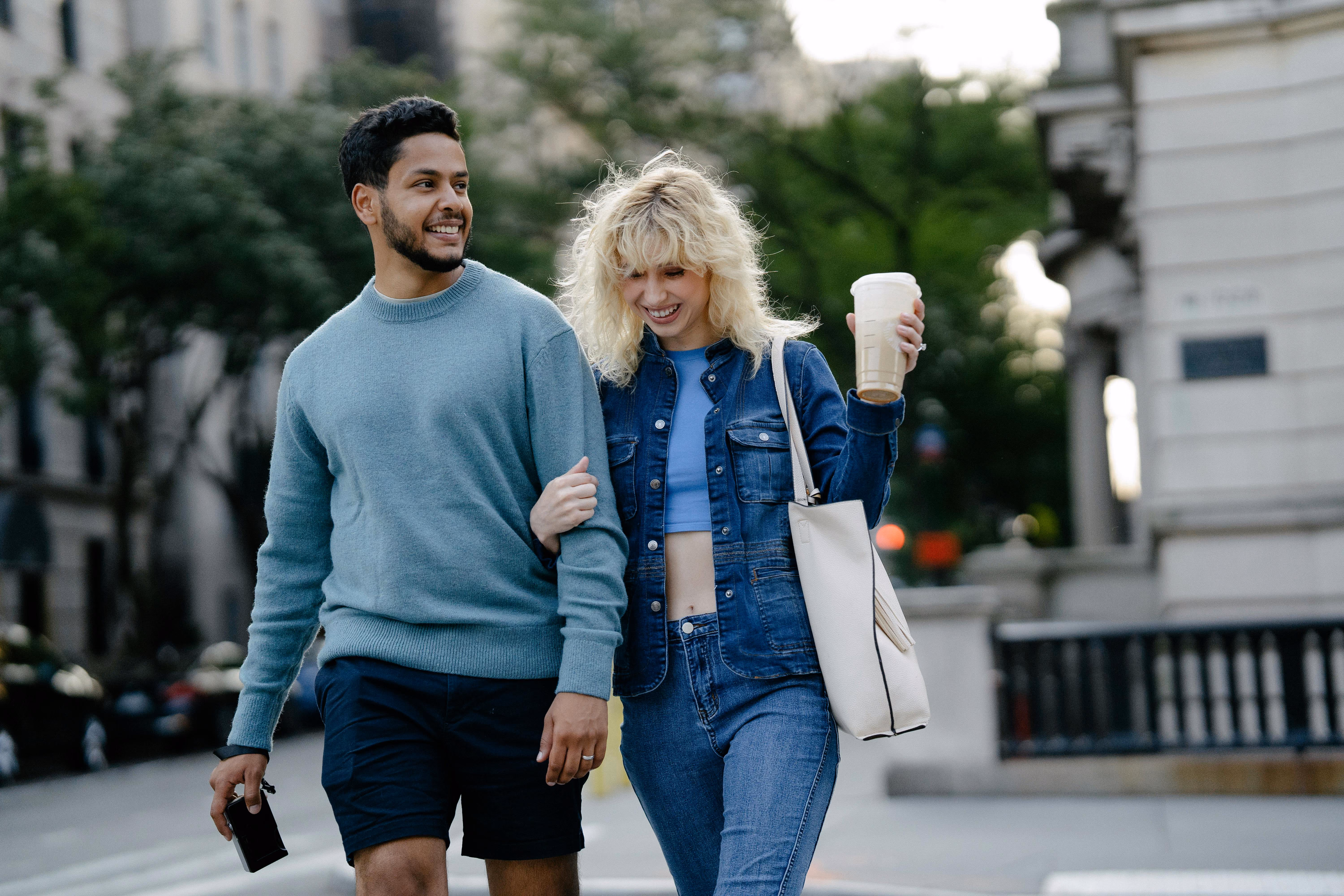 Couple walking with coffee stock image