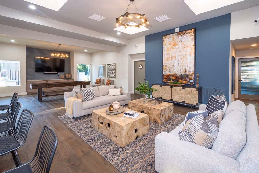 Clubhouse seating and kitchen area with sofa, tv, and table