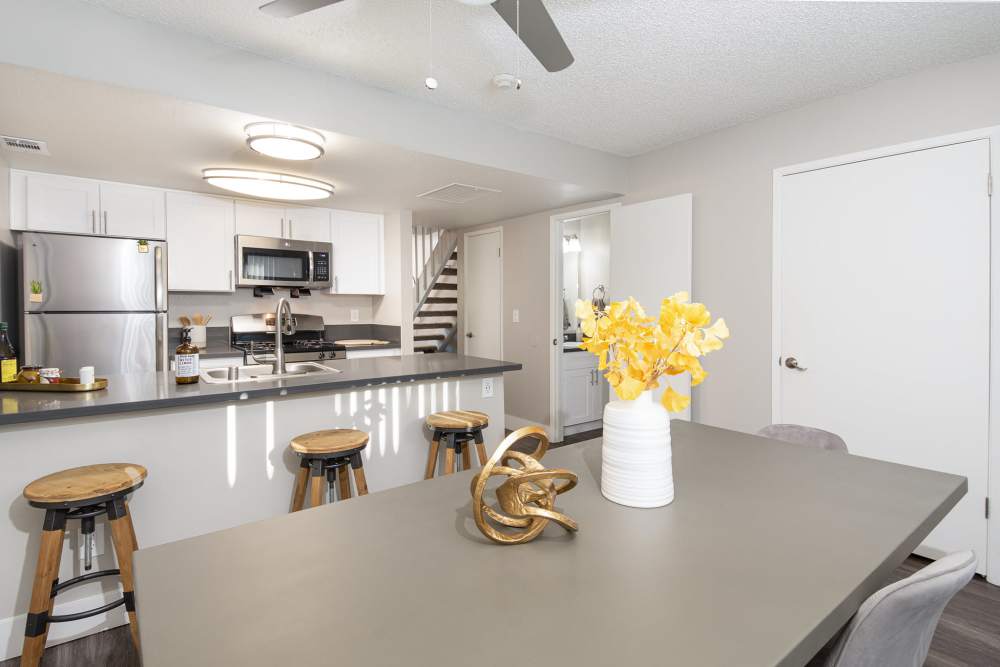 Dining area with table and kitchen with island