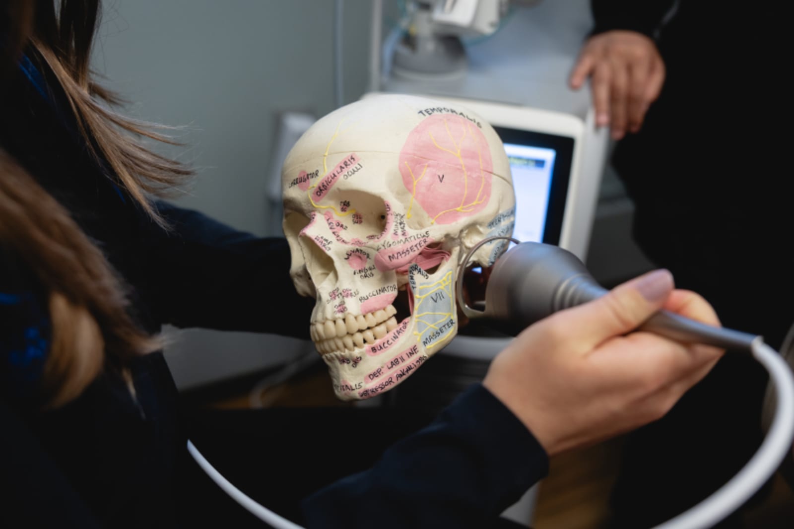 TMJ disorder patient seeing craniofacial examination demonstration at Minnesota Craniofacial Center for jaw pain and migraine relief.