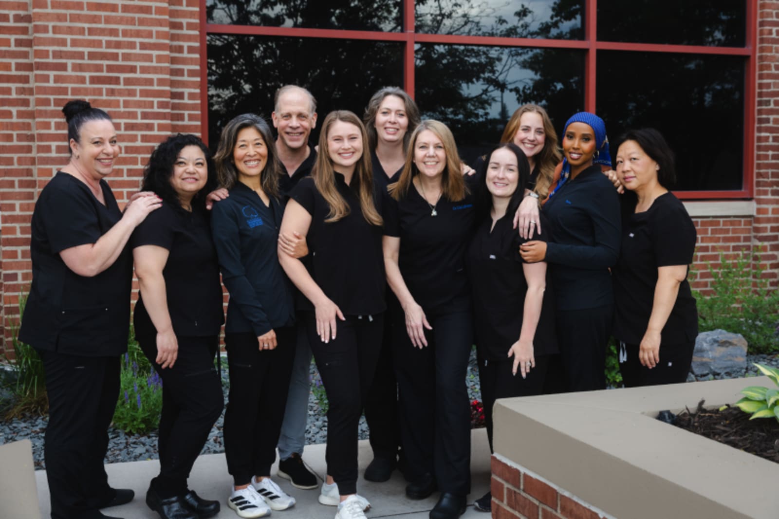 Minnesota Craniofacial Center team posing outside brick building entrance
