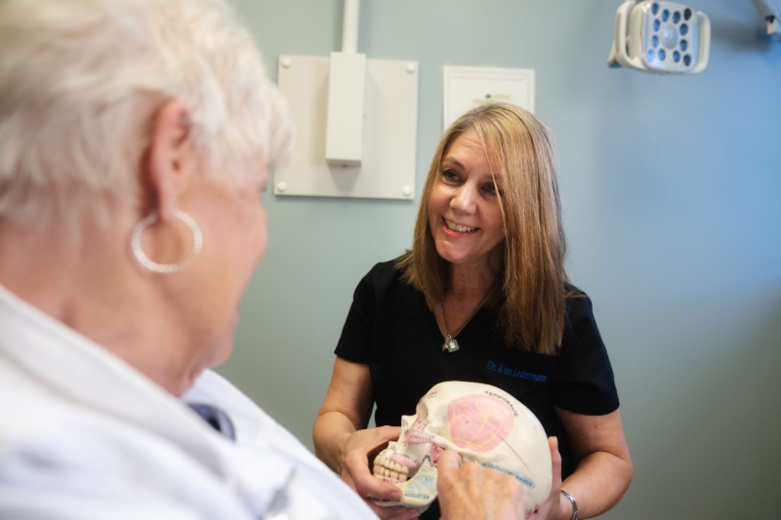 Dentist conducting a specialized dental examination with patient in clinical setting