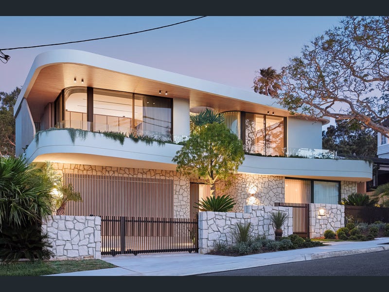 3 Methuen Avenue, Mosman at dusk — curved white facade over sandstone walling
