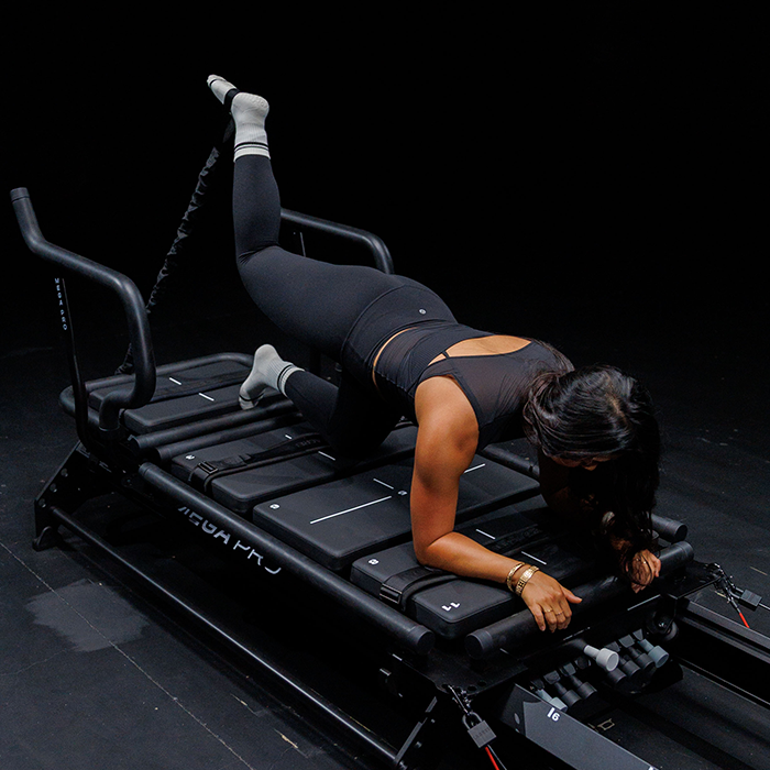 Pono Lagree client performing a full-body Megaformer exercise