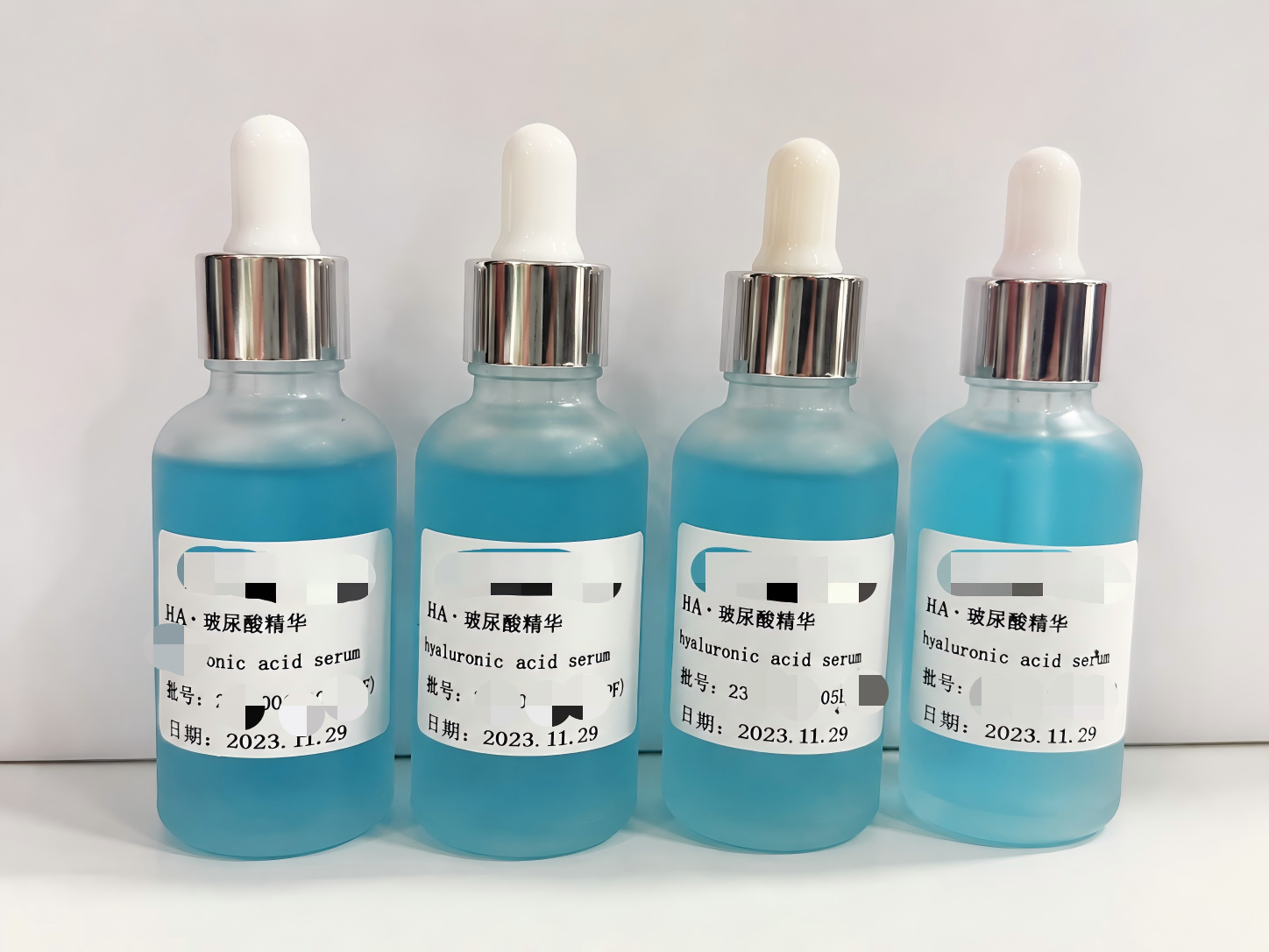 Black glass pump bottle sample of the private label hyaluronic acid serum developed with Enrich Lab