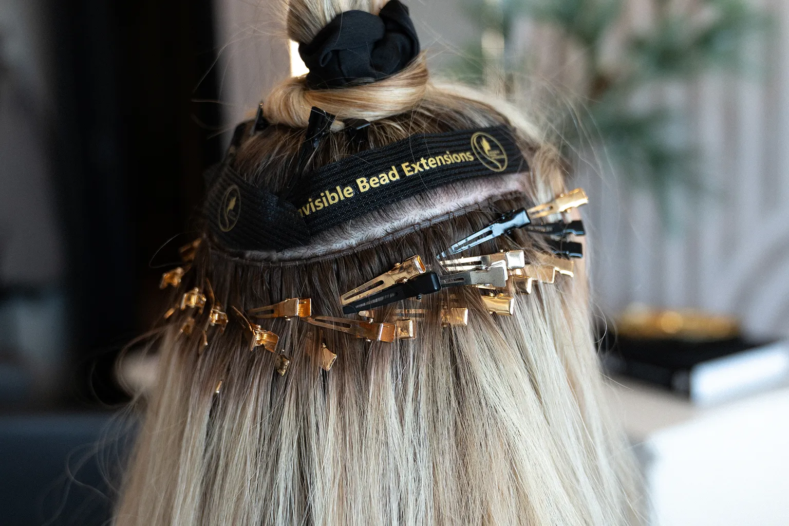 Invisible Bead Extensions® installation showing concealed beaded rows before hand-tied wefts are sewn into place.