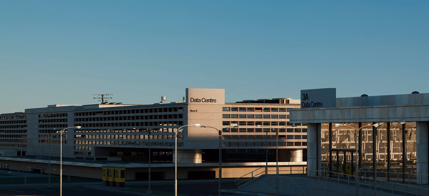 Exterior view of a large data center complex with multiple blocks under clear sky light.