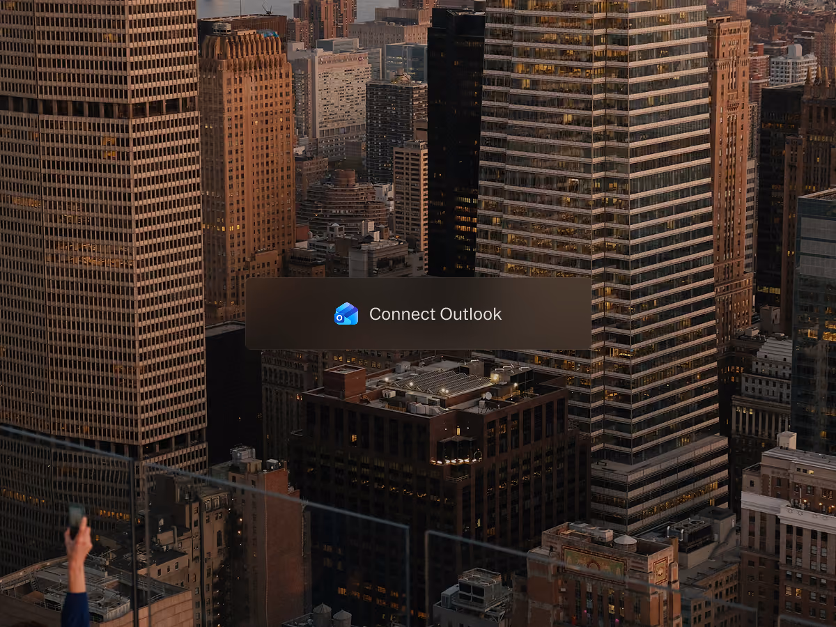 Cityscape of tall buildings at sunset with a button in the center reading Connect Outlook.