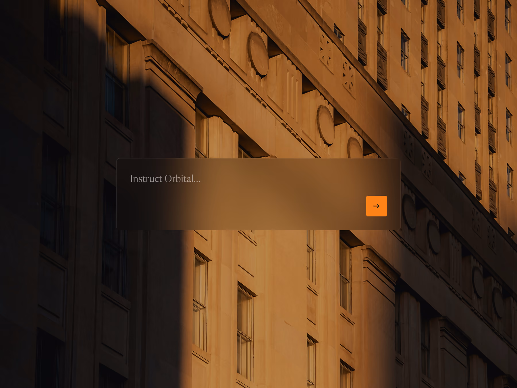 Sunlit classic building facade with decorative details and shadowed windows in warm light.