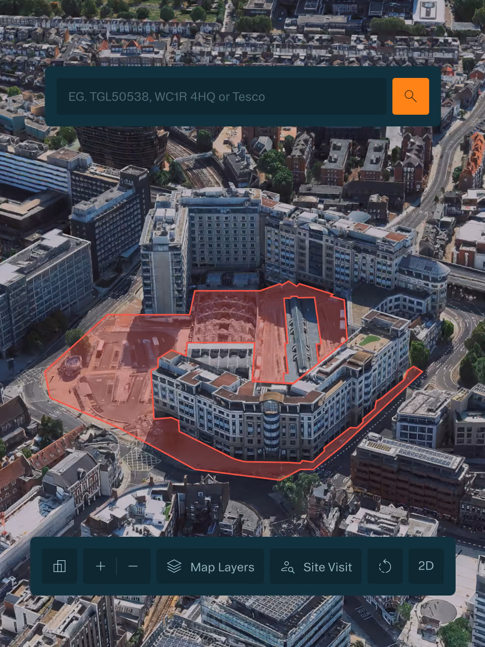 Aerial city view with a large building complex outlined in red and search bar at the top.