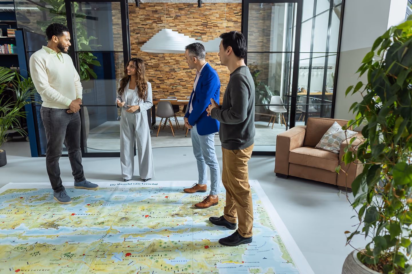 Four colleagues standing on the Floormap in an office