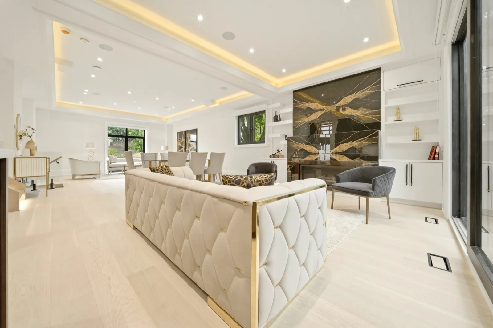 HDR living room photo — gold marble fireplace wall and staged seating