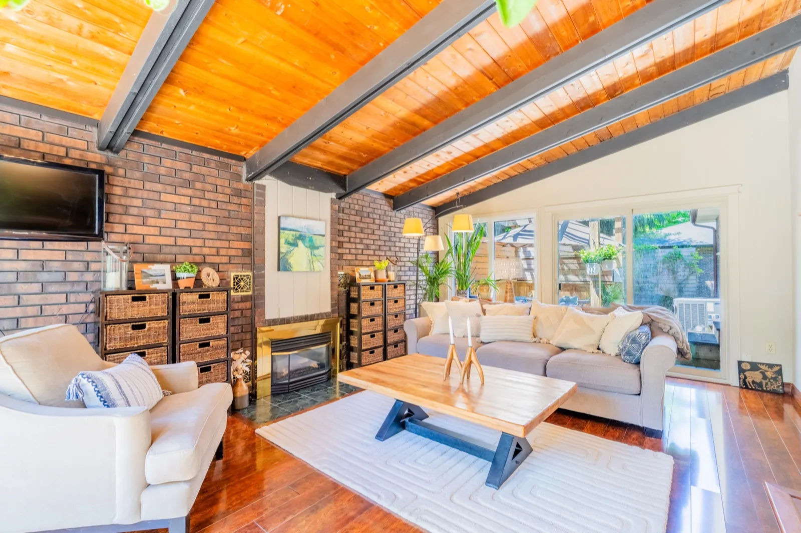 4 Cedar St, Port Colborne — living room with exposed-beam wood ceiling and brick wall