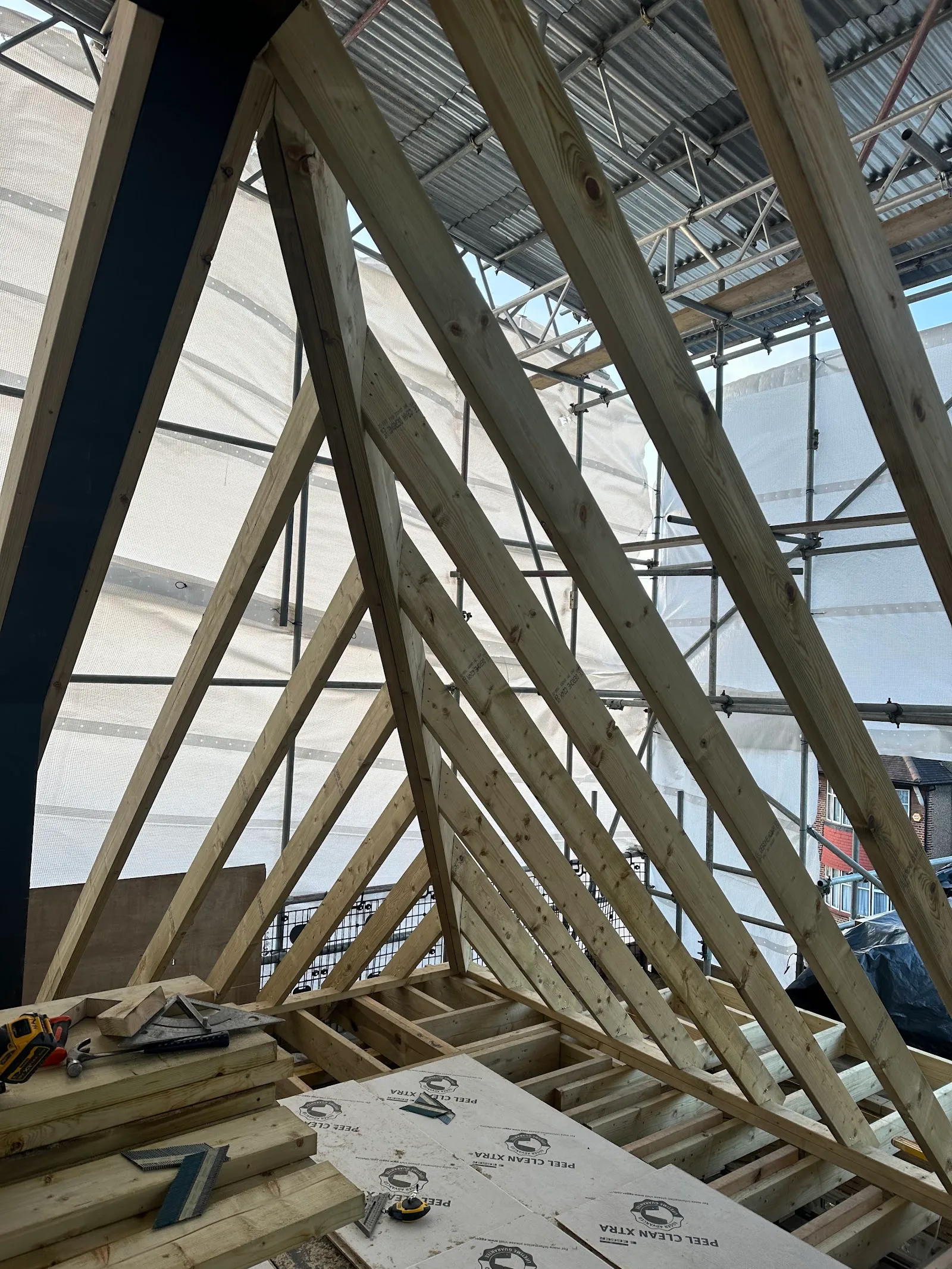 New timber rafters framed against the steel during a Southgate loft conversion