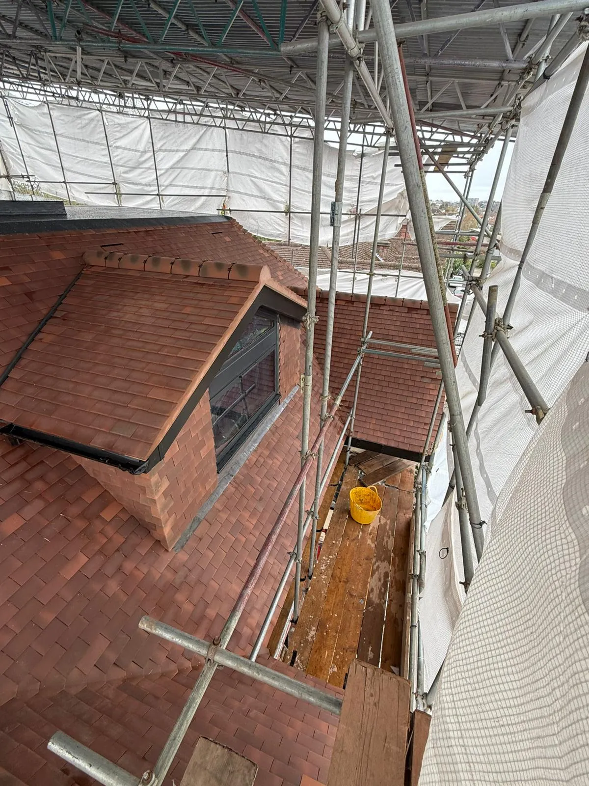 Bonnet hip clay tiling detail on a rebuilt roof in Southgate N14