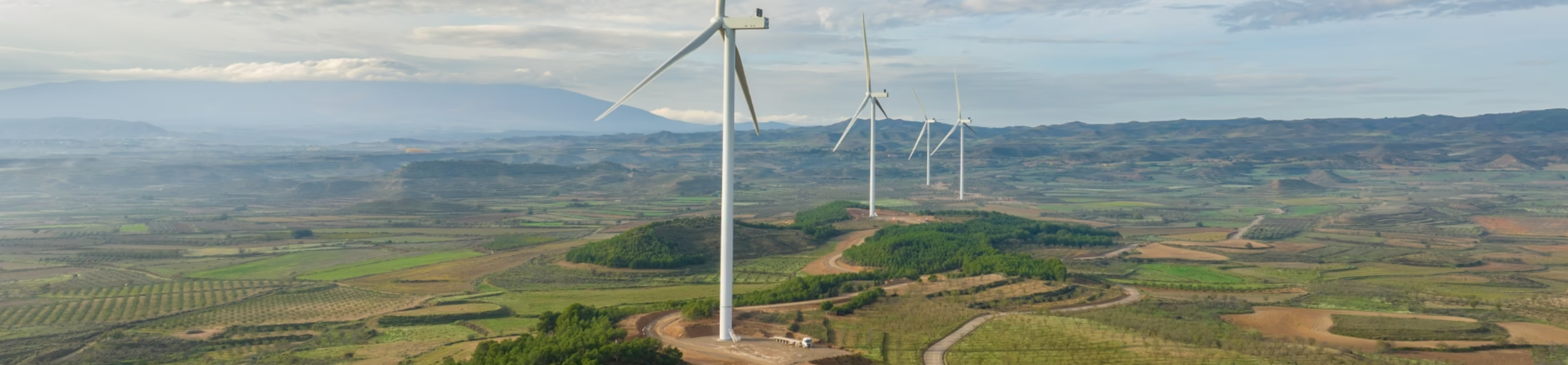 Wind turbines across an agricultural landscape