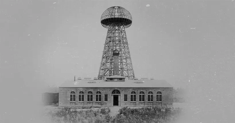 Historic black-and-white photograph of Nikola Tesla's Wardenclyffe Tower and its brick laboratory building