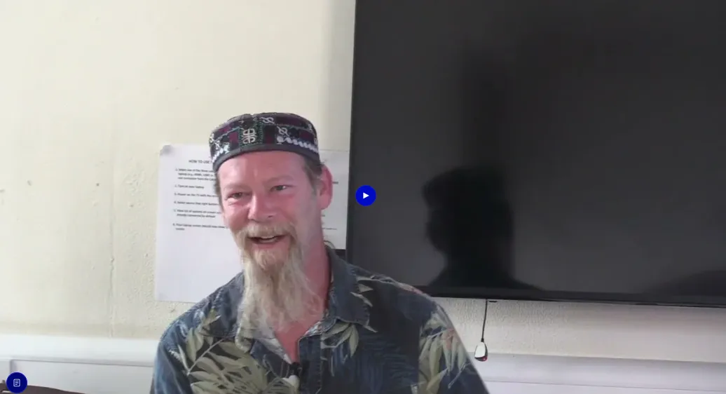 Video thumbnail of a bearded man speaking to camera in a workshop in front of a wall-mounted TV screen