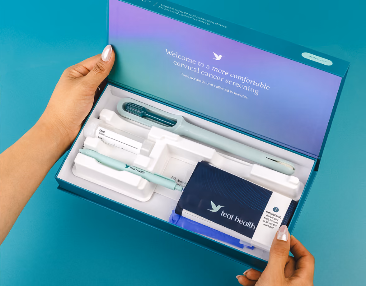 Hands holding an open Teal Health kit box reading 'Welcome to a more comfortable cervical cancer screening.'