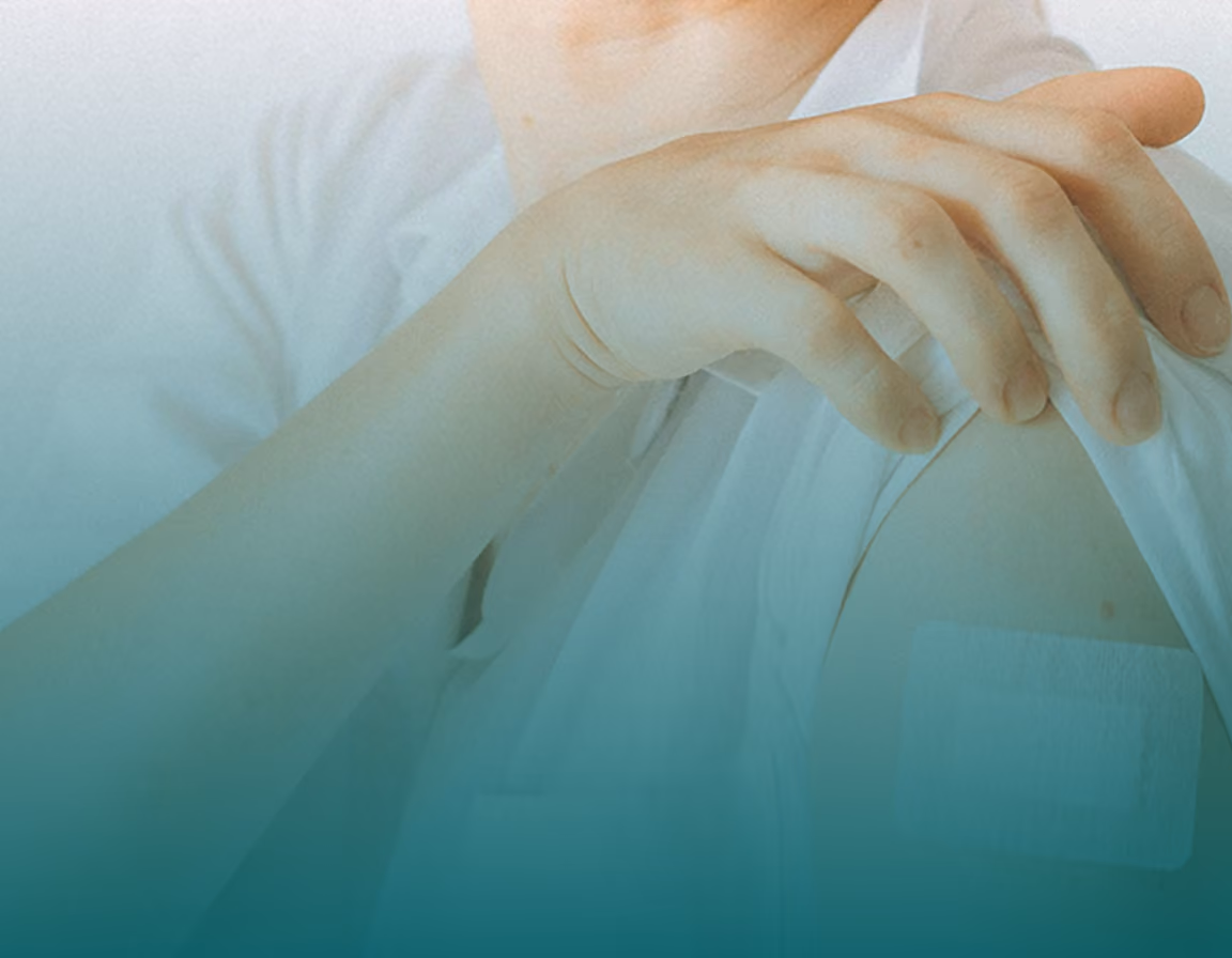 A close-up shot of a person’s upper arm with a white bandage on their shoulder after receiving a shot, representing preventative care and the HPV vaccine for cervical cancer prevention.