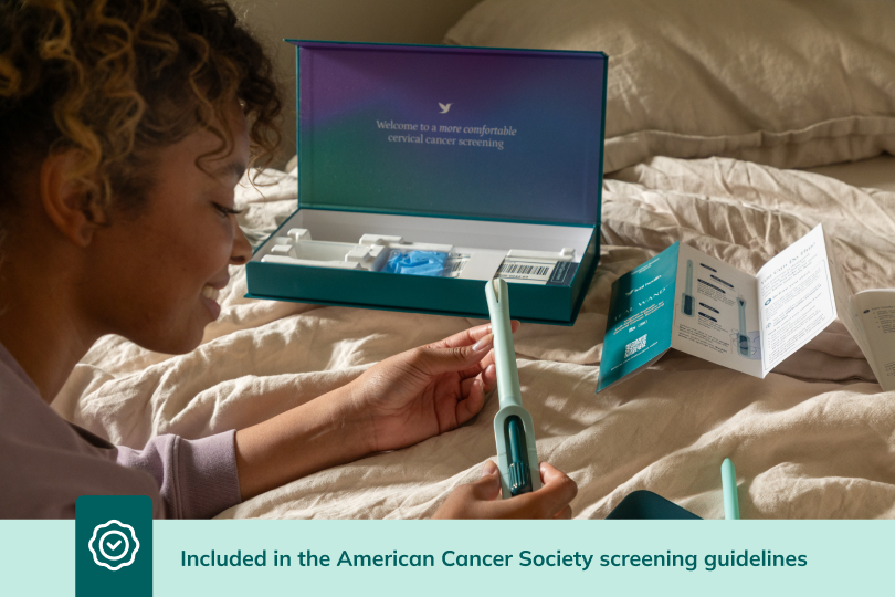 Woman on a bed holding the teal wand by an open kit; caption reads 'Included in the American Cancer Society guidelines.'